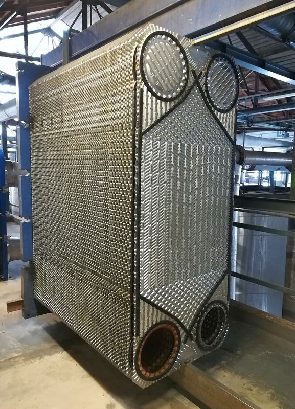 A dismantled plate heat exchanger showing its stack of metal plates